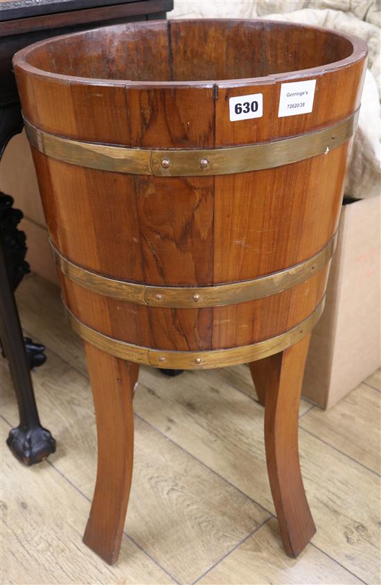 A staved and coopered teak jardiniere stand, W.70cm